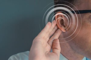 Person bending their ear to attempt to listen better